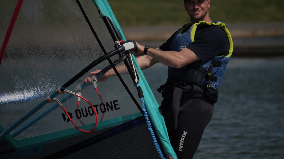 Catch the wind and speed across the water in a introductory windsurfing session